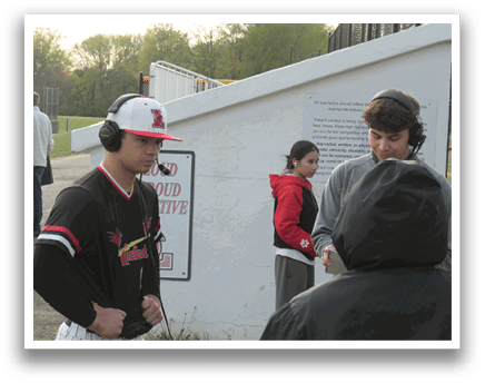 A man wearing a baseball uniform is standing next to a woman. Description generated by AI