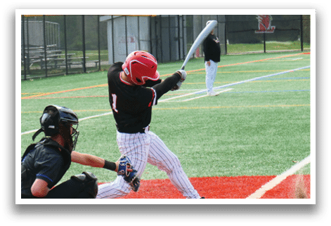 A baseball player is swinging a bat on a field. Description generated by AI