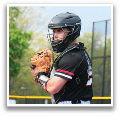 A baseball player wearing a black and red shirt and a black helmet. Description generated by AI