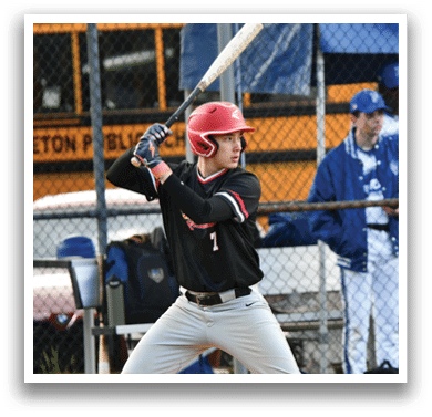 A baseball player in a black shirt and red helmet is holding a bat and getting ready to swing. Description generated by AI