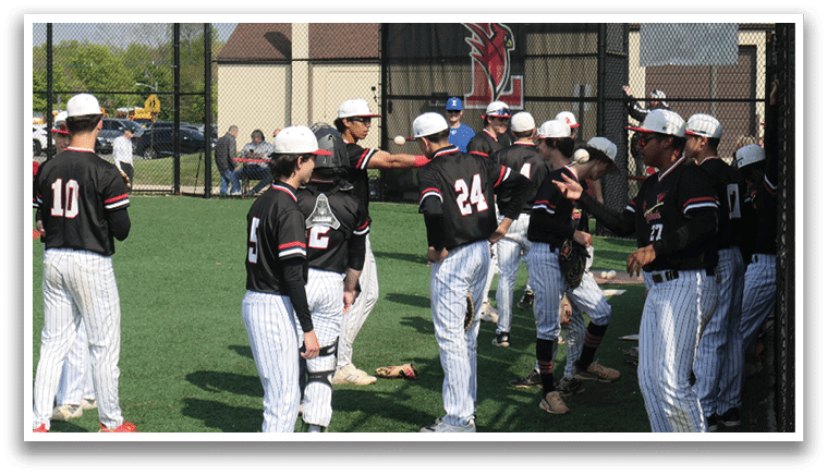A group of baseball players standing on a field. Description generated by AI