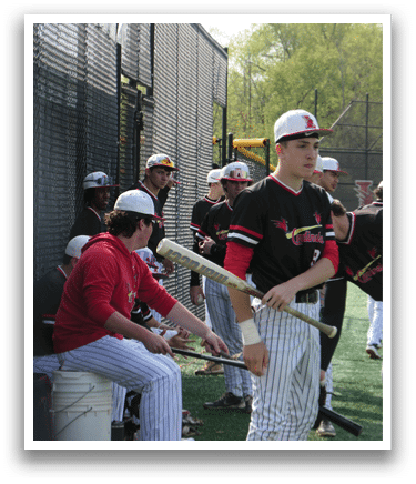A baseball player holding a bat. Description generated by AI