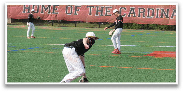 A baseball player in a black shirt and white pants is catching a ball. Description generated by AI