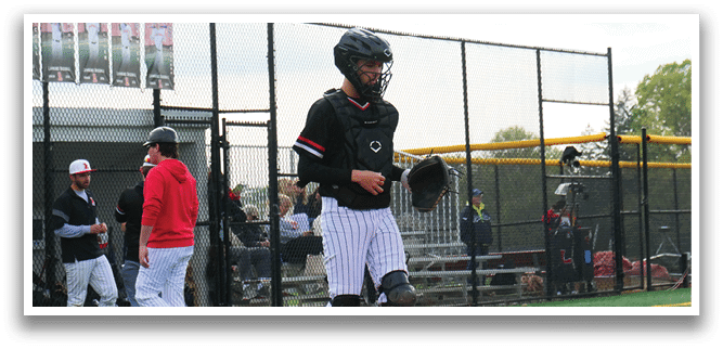 A baseball player wearing a black helmet and white pants. Description generated by AI