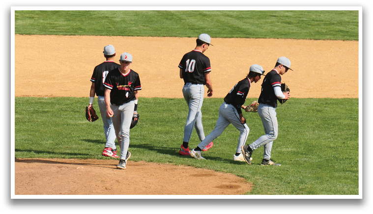 Three baseball players walking on a field. Description generated by AI