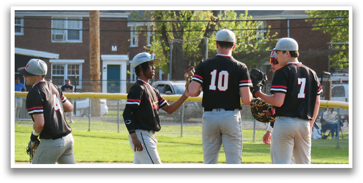 A group of baseball players on a field. Description generated by AI