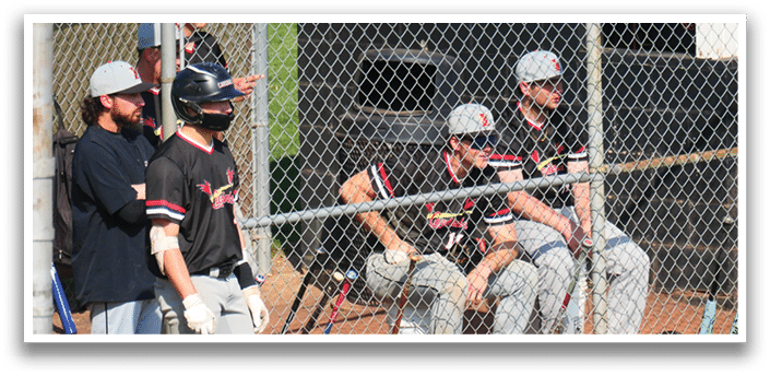 A group of baseball players are sitting on the bench. Description generated by AI