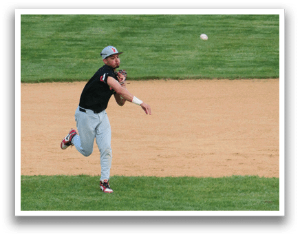 A baseball player catching a ball. Description generated by AI