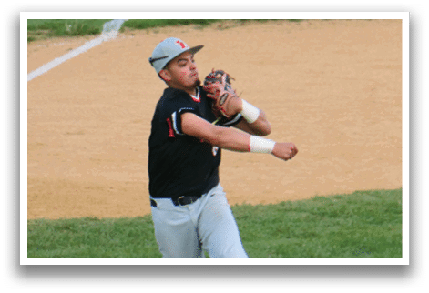 A baseball player in a black shirt and white pants catching a ball. Description generated by AI