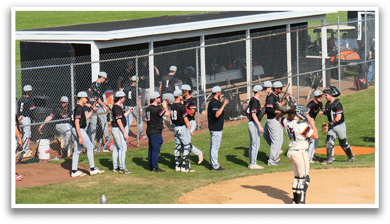 A baseball field with a group of people standing on it. Description generated by AI