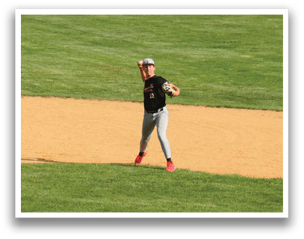 A baseball player is standing on the field. Description generated by AI