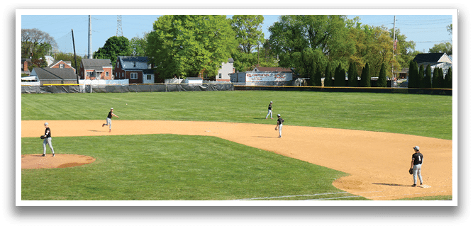 A baseball game is being played on a field with a group of men. Description generated by AI