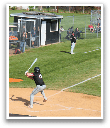 A baseball player is swinging a bat at a ball. Description generated by AI
