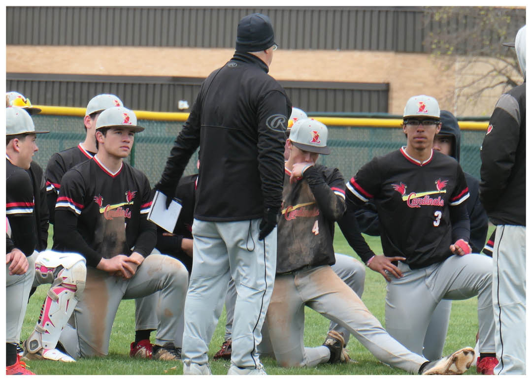 A group of baseball players wearing black and red uniforms. Description generated by AI