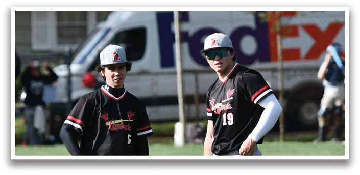 Two baseball players standing on a field. Description generated by AI