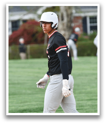 A baseball player wearing a black shirt and white pants. Description generated by AI