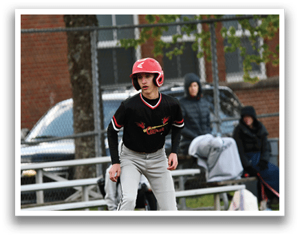A baseball player wearing a red helmet and black shirt. Description generated by AI