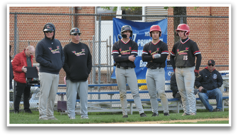 Baseball players standing on a field. Description generated by AI