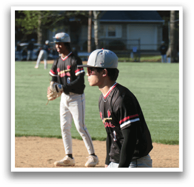 Two baseball players standing on a field. Description generated by AI