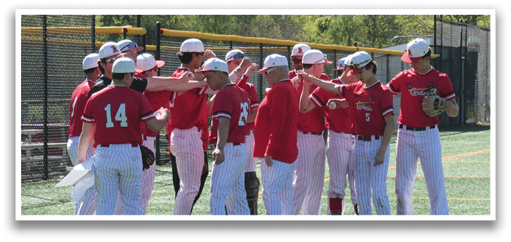 Baseball players wearing red shirts and white pants. Description generated by AI