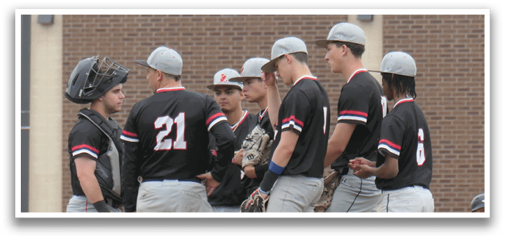 A group of baseball players wearing black and white uniforms. Description generated by AI