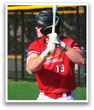 A baseball player wearing a red shirt and white pants is holding a bat. Description generated by AI