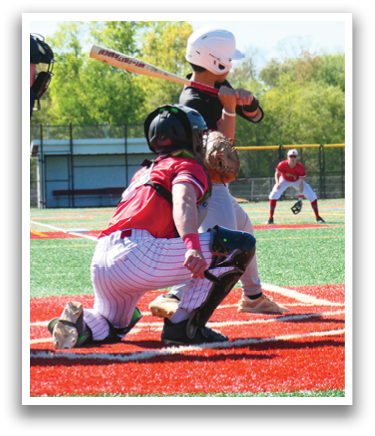 A baseball player is holding a bat and getting ready to hit the ball. Description generated by AI