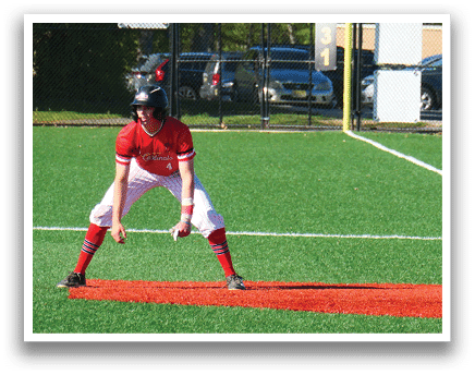 A baseball player is holding a baseball bat, ready to hit the ball. Description generated by AI