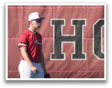 A baseball player wearing a red shirt and white pants. Description generated by AI