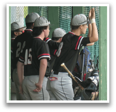 A group of baseball players in a dugout. Description generated by AI