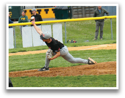 A baseball player in a black shirt and grey pants is pitching a ball. Description generated by AI