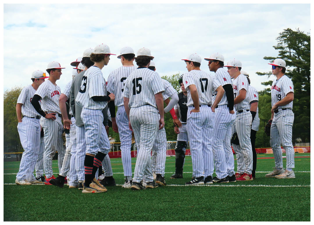 A group of baseball players standing on a field. Description generated by AI