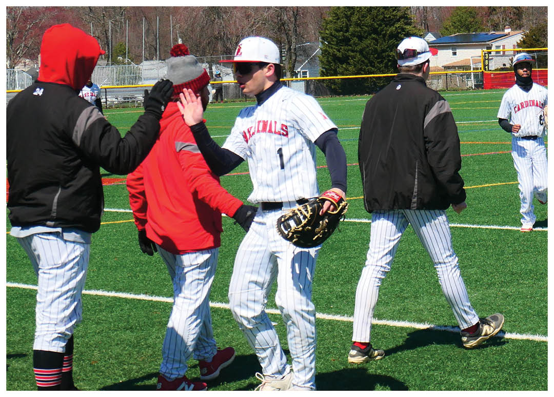 A group of baseball players on a field. Description generated by AI