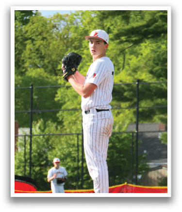 A baseball player in a red and white uniform is on the pitcher's mound. Description generated by AI