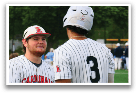 Two baseball players wearing red and white uniforms. Description generated by AI
