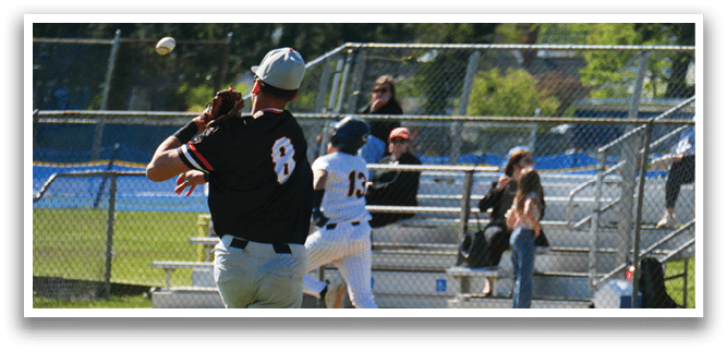 A baseball player wearing a black shirt with the number 8 on it. Description generated by AI