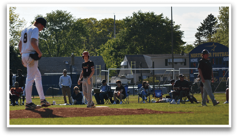 A baseball player is standing on the pitcher's mound. Description generated by AI