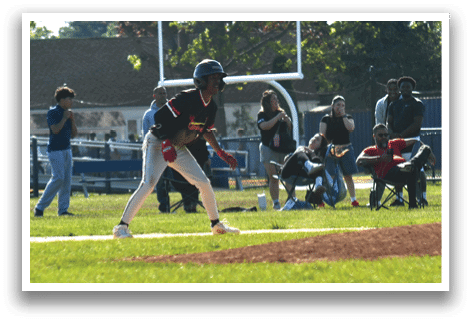 A baseball player is standing on the field with a bat. Description generated by AI