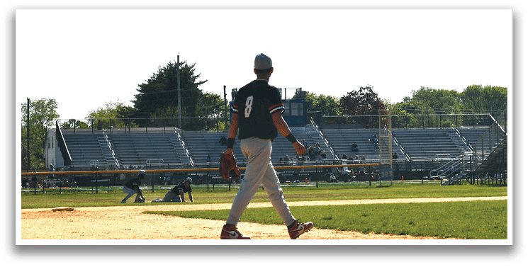 A baseball player wearing a black shirt and red shoes. Description generated by AI