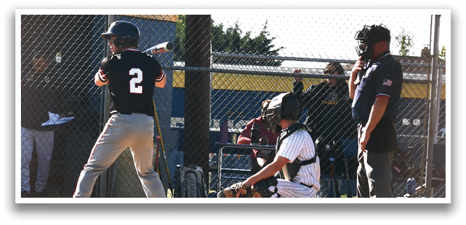 A baseball player is at bat, holding a bat and waiting for the pitch. Description generated by AI