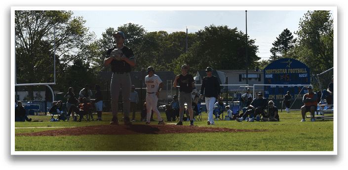 A baseball game is taking place on a field with a crowd of people watching. Description generated by AI