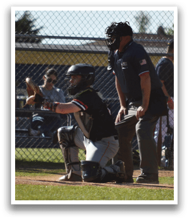 A baseball player is holding a bat and getting ready to hit the ball. Description generated by AI