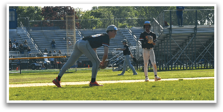 A baseball game is being played on a field with a man in a black shirt and red shoes running towards a base. Description generated by AI
