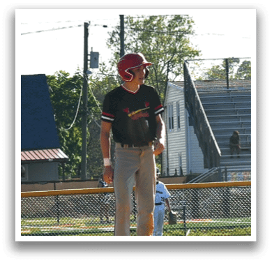 A baseball player standing on a field. Description generated by AI