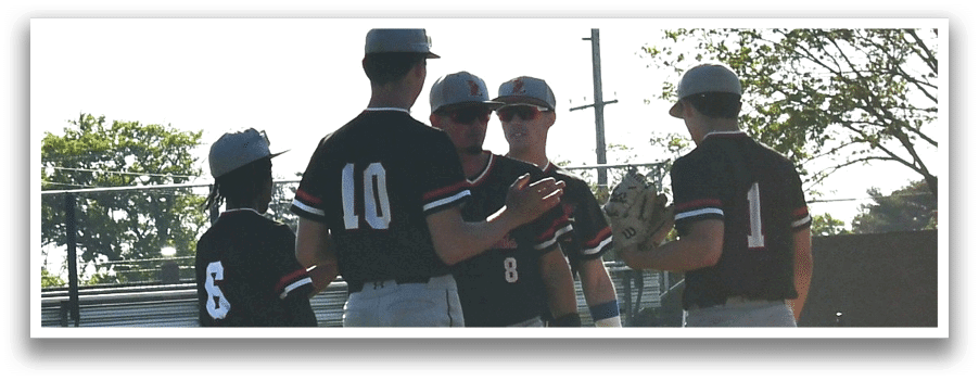 A group of baseball players wearing black and white uniforms. Description generated by AI