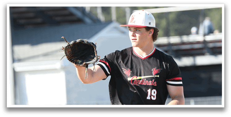 A baseball player wearing a black shirt and white pants holding a baseball glove. Description generated by AI