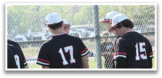 A group of baseball players wearing black and white uniforms. Description generated by AI