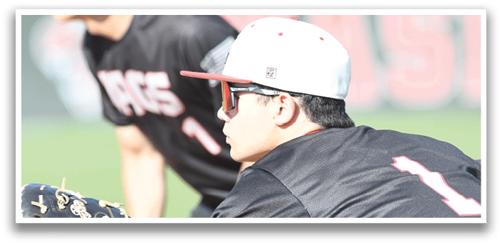A baseball player wearing a black shirt and red hat. Description generated by AI