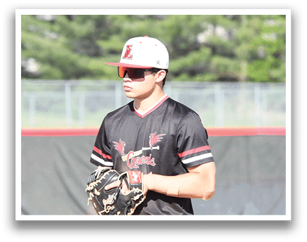 A baseball player wearing a black and red shirt and a white cap. Description generated by AI