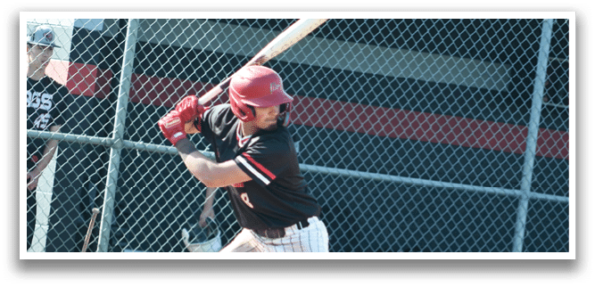 A baseball player in a red helmet and black shirt is swinging a bat. Description generated by AI